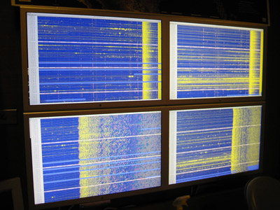 Photo of monitors displaying real time waveforms 
                created by the Alaska and Peru earthquakes of August 15, 2007
